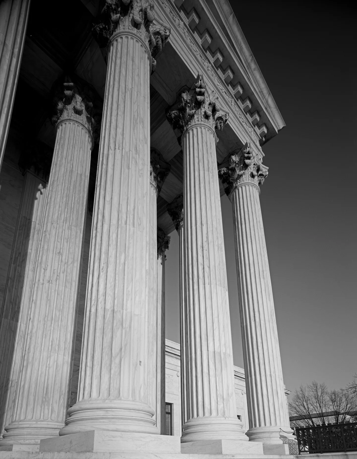 Fluted marble columns of the Supreme Court building, in black and white.